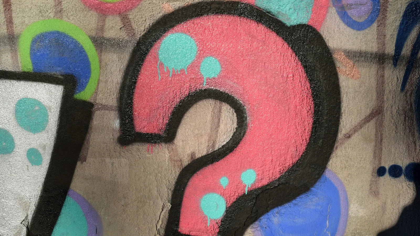 A pink question mark painted on a wall