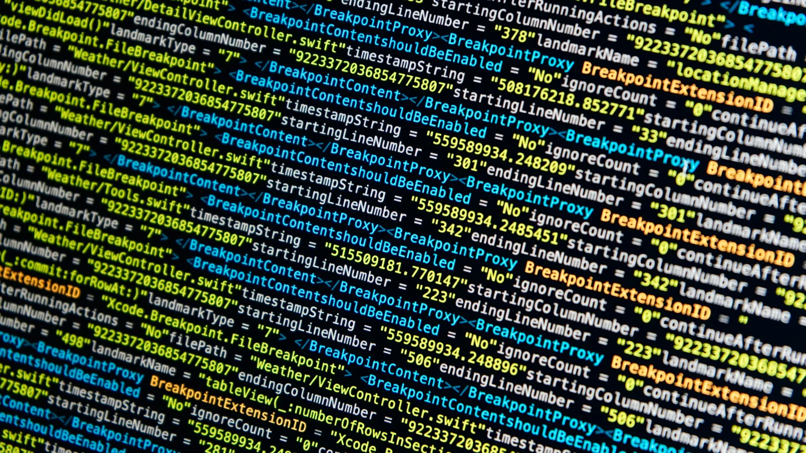 Lines of colourful code on a screen, seen at an angle
